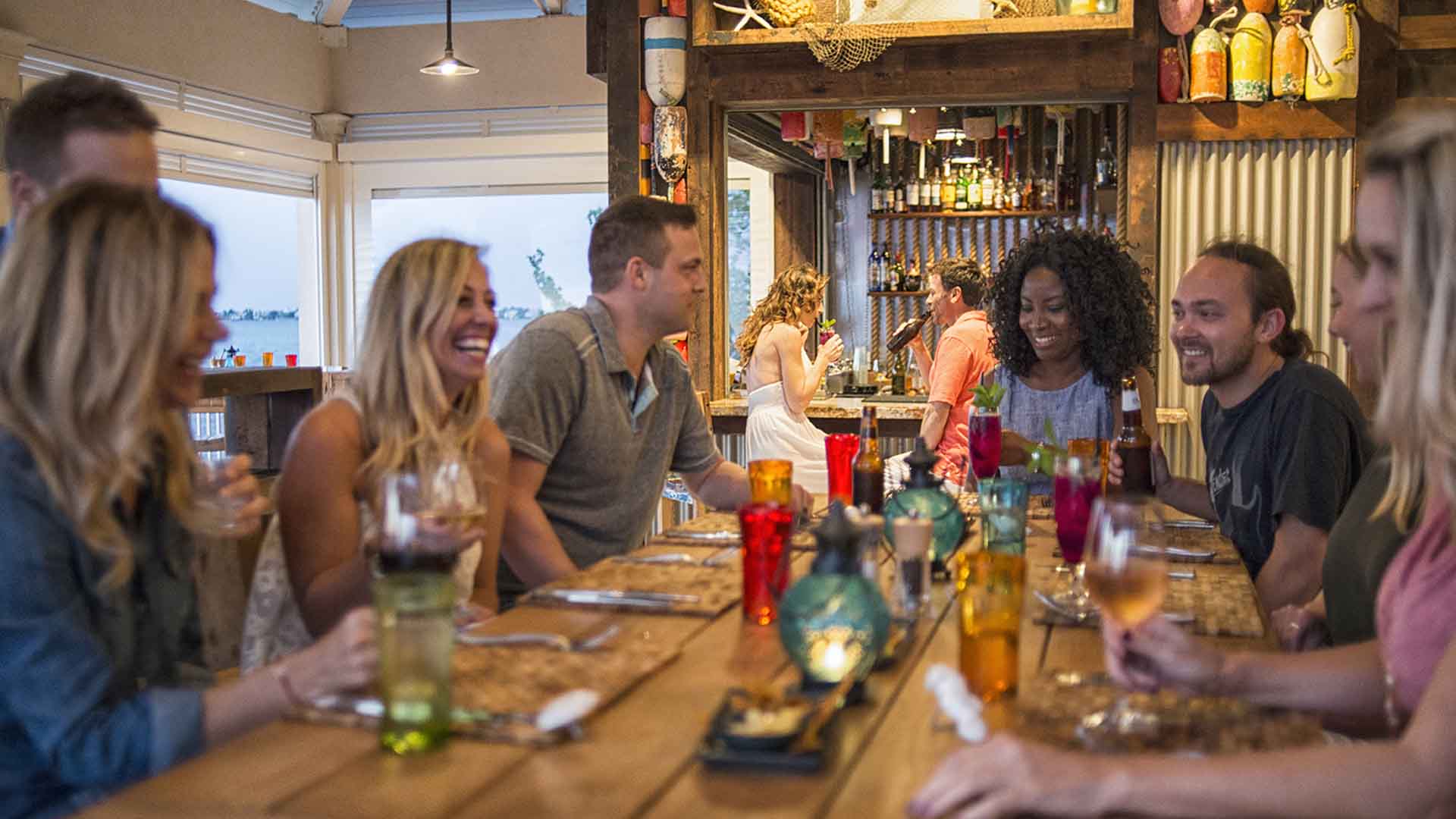 Friends seated around a dining table at Sol by the Sea restaurant at Playa Largo Resort and Spa